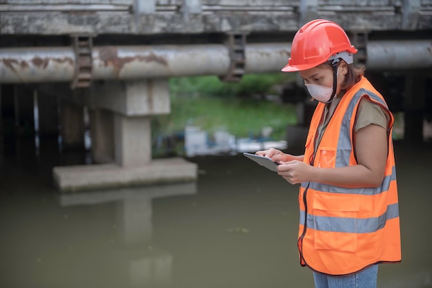 An advanced electrical engineer inspects the electrical system\
of the waterworksmaintenance technicians for the control system of\
the wastewater treatment system