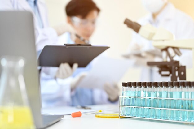 Advanced equipments on the table with blurred background of a group of scientist having the meeting