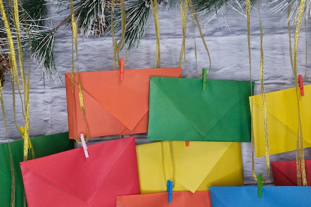 Advent calendar on a background of a brick wall. Multicolored envelopes made by hand.