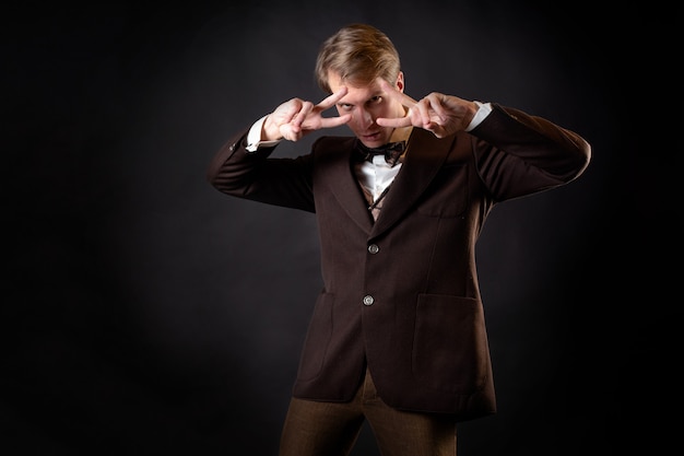 An adventurer, a character in a steampunk-style story.\
intelligent gentleman in the victorian style. vintage retro suit,\
young attractive man in a vest and bow tie