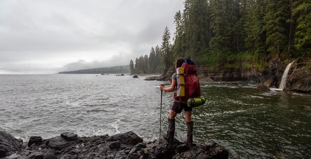 Adventurous girl hiking Juan de Fuca Trail to Sombrio Beach on the Pacific Ocean Coas