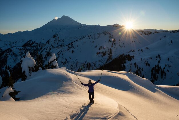 Adventurous girl is enjoying the Moutain Landscape during a vibrant sunset