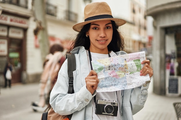 Adventurous Latina tourist explores new city with camera