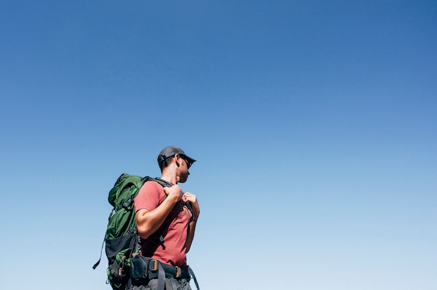 Adventurous man with backpack outdoors