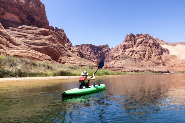 Adventurous Woman on a Kayak paddling in Colorado River