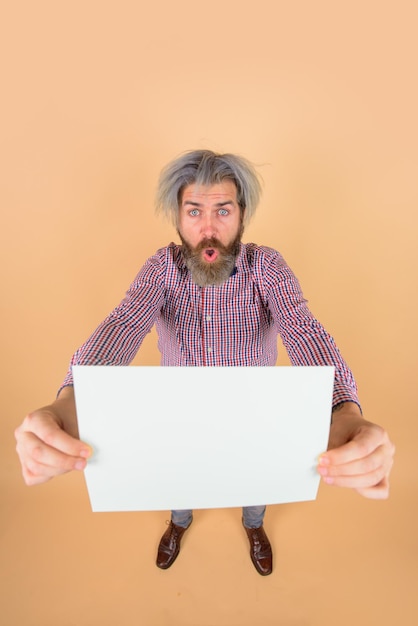 Advertising board copy space for text surprised man with blank board space for text bearded man