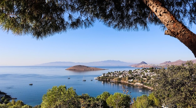 Aegean coast with marvelous blue water, rich nature, islands, mountains and small white houses