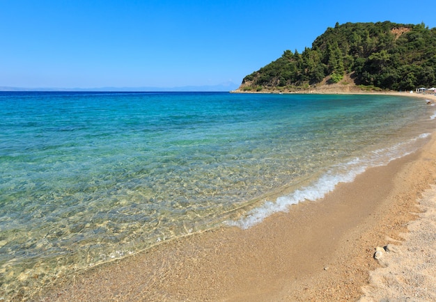 Aegean sea coast landscape, view from sandy beach (Chalkidiki, Greece).