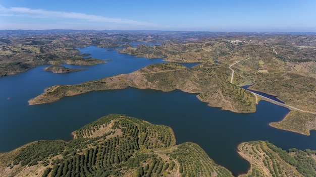 Aerial. Barrage of Odeleite. Flying a drone over the lake.