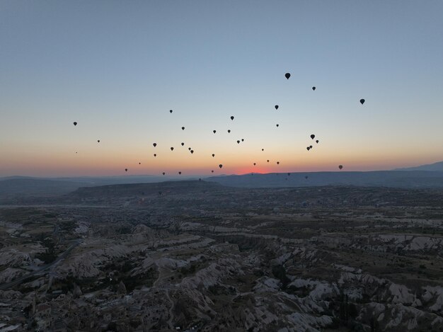 Aerial cinematic drone view of colorful hot air balloon flying over Cappadocia