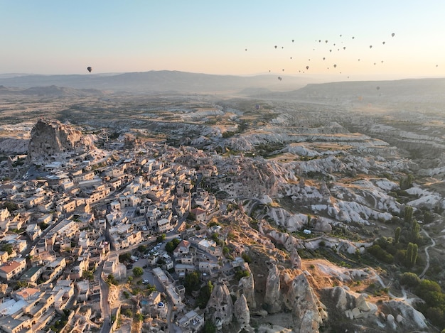 Aerial cinematic drone view of colorful hot air balloon flying over Cappadocia