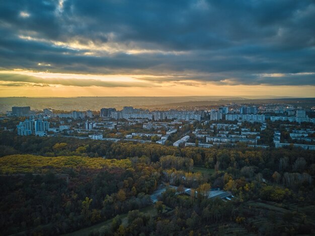 Aerial over the city in autumn at sunset