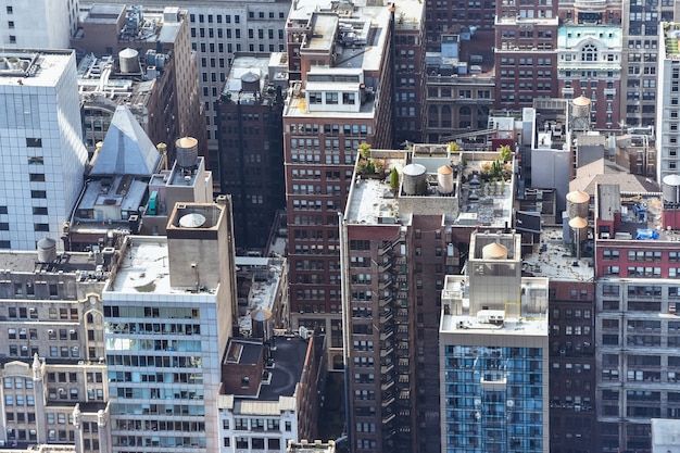 Aerial close up view of crowded buildings in New York City on a sunny day. Construction concept, crowded cities, and apartment rentals. NYC, USA.