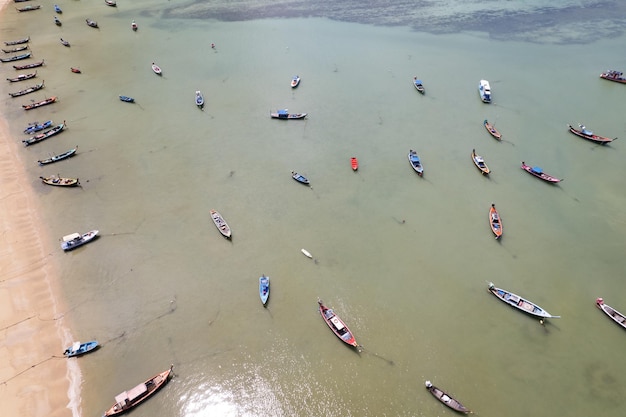 Aerial drone bird\'s eye view photo top down of tropical sea\
with long tail fishing boats travel boats at phuket thailand\
amazing top view sea beautiful sea surface