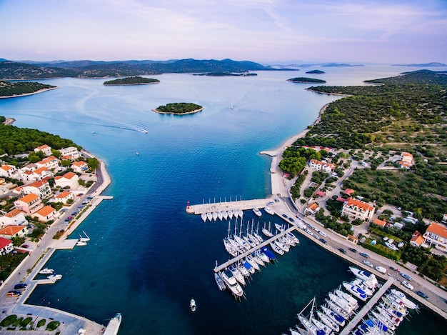 Aerial drone bird's eye view of small marina with boats and yachts docked in Croatia