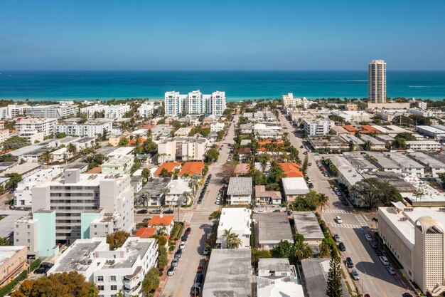 Aerial drone photoshoot commercial area luxury houses beach with turquoise water sky and canal