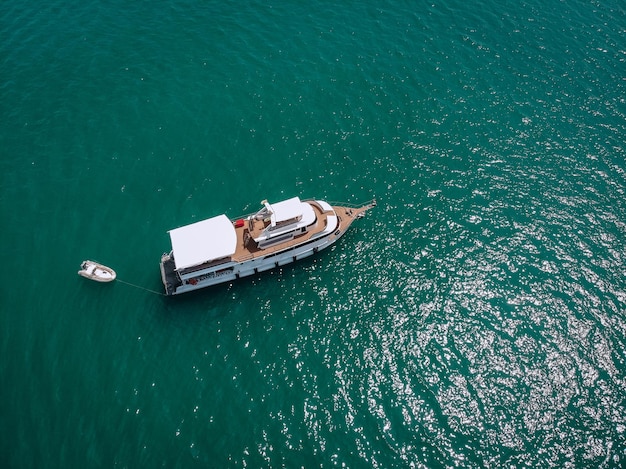 Foto aerea di vista dall'alto del drone di yacht di lusso con gommone bianco. phuket. tailandia.