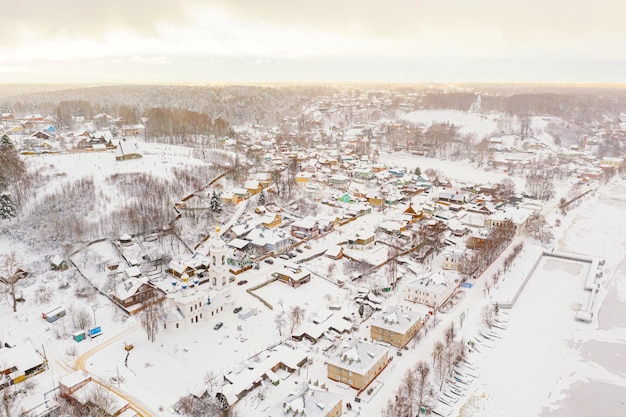 Aerial drone view of ancient russian town Ples on the Volga river in winter with snow Ivanovo region