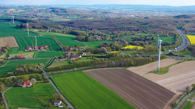 Aerial drone view of asparagus fields and yellow rapeseed fields in German countryside