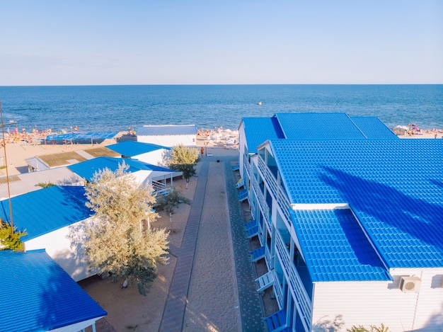 Aerial drone view of blue houses near ocean