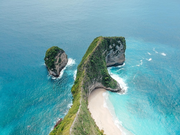 Aerial drone view of blue ocean view of seashore at Manta Bay or at Kelingking Beach on Nusa Penida Island Bali Indonesia