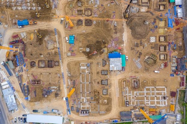 Aerial drone view of excavator loading the tipper truck at the construction site