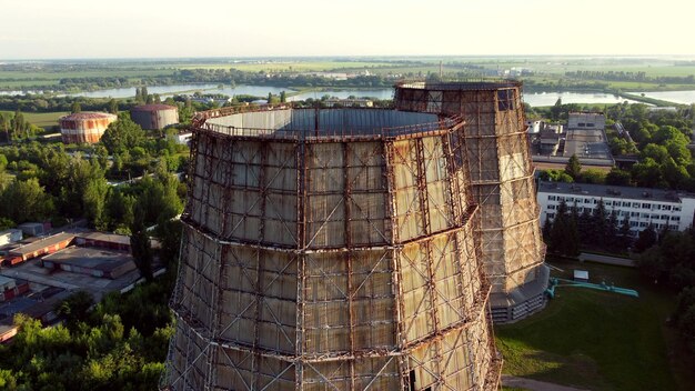 Aerial drone view flight near thermal power plant cooling towers of chp