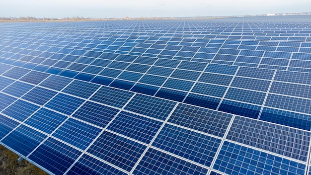 Aerial drone view flight over solar panels on sunny day closeup photovoltaic