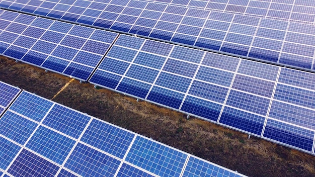 Aerial drone view flight over solar power station panels aerial top view of solar farm green energy