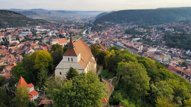 Aerial drone view of the Historic Centre of Sighisoara Romania Church on the Hill surrounded