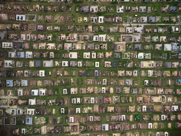 Aerial drone view of a large cemetery, graves and green grass around