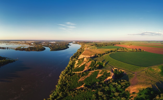 Aerial drone view of river landscape in sunny summer evening