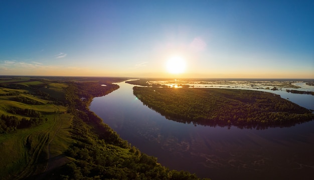 Aerial drone view of river landscape in sunny summer evening