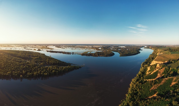 Aerial drone view of river landscape in sunny summer evening