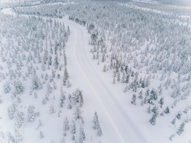 Aerial drone view of road in idyllic winter landscape Finland Lapland