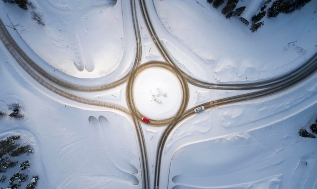 Aerial drone view of road in idyllic winter landscape Street running through the nature from a birds eye view