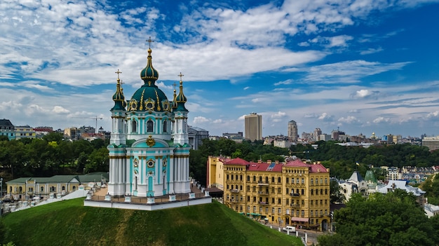 Aerial drone view of Saint Andrew's church and Andreevska street from above, cityscape of Podol district, city of Kiev (Kyiv), Ukraine