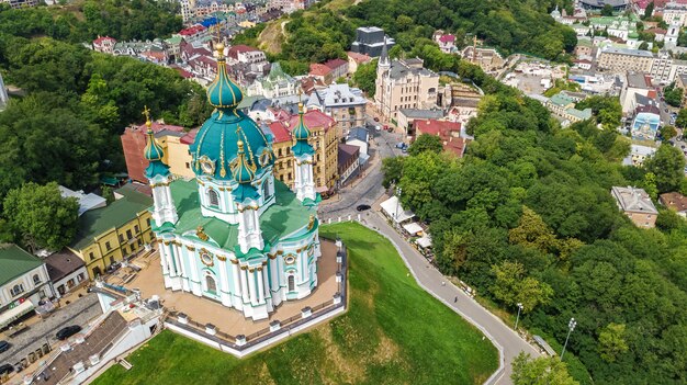 Aerial drone view of Saint Andrew's church and Andreevska street from above, cityscape of Podol district, city of Kiev (Kyiv), Ukraine