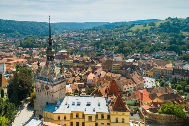 Aerial drone view of Sighisoara old city and clock tower Romania Mures County