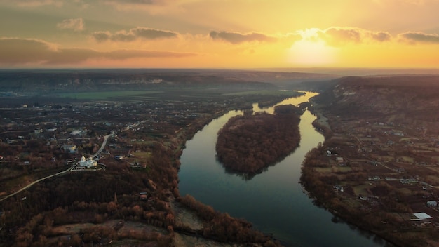 Aerial drone view of a village in Moldova at sunset River old residential buildings church