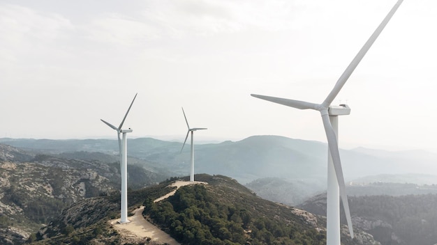 Aerial drone view on wind farm with windmill turbines on the mountain