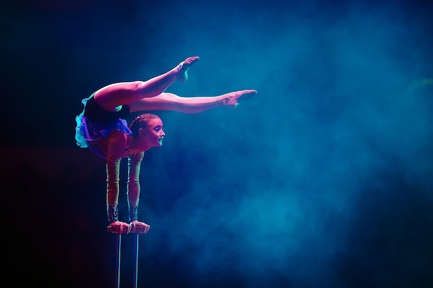 An aerial gymnast shows a performance in the circus arena.