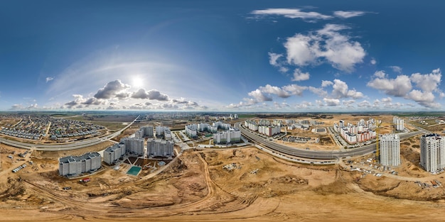 Aerial hdri 360 panorama view over construction of new modern residential complex with highrise buildings in town in equirectangular seamless spherical projection