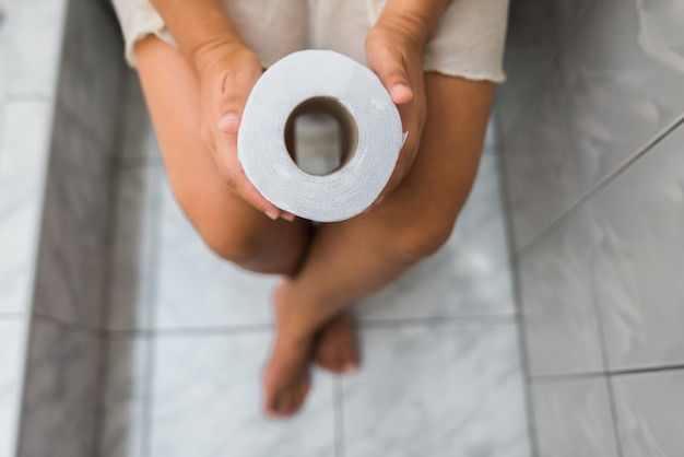 Aerial image of a woman with paper in her hands in the bathroom