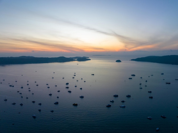 Aerial landscape Seascape Chalong pier with sailboats Yacht boats and Travel boats in the sea Amazing sunset or sunrise sky over sea Drone flying shotTop down view