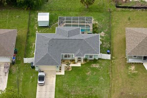 Aerial landscape view of suburban private houses between green palm trees in florida quiet rural area