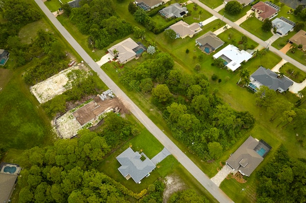 Aerial landscape view of suburban private houses between green palm trees in Florida quiet rural area