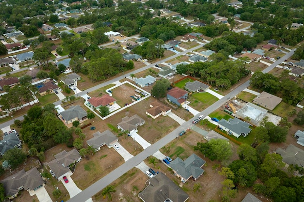 Aerial landscape view of suburban private houses between green palm trees in Florida rural area