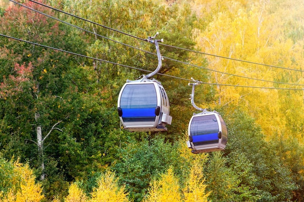 Aerial lift to the mountain in the autumn forest