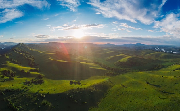 Aerial panorama drone shot of beauty dawn on the peak in the mountains in altay summertime